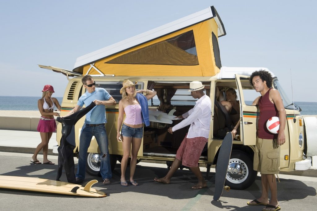 Group of young people by a campervan