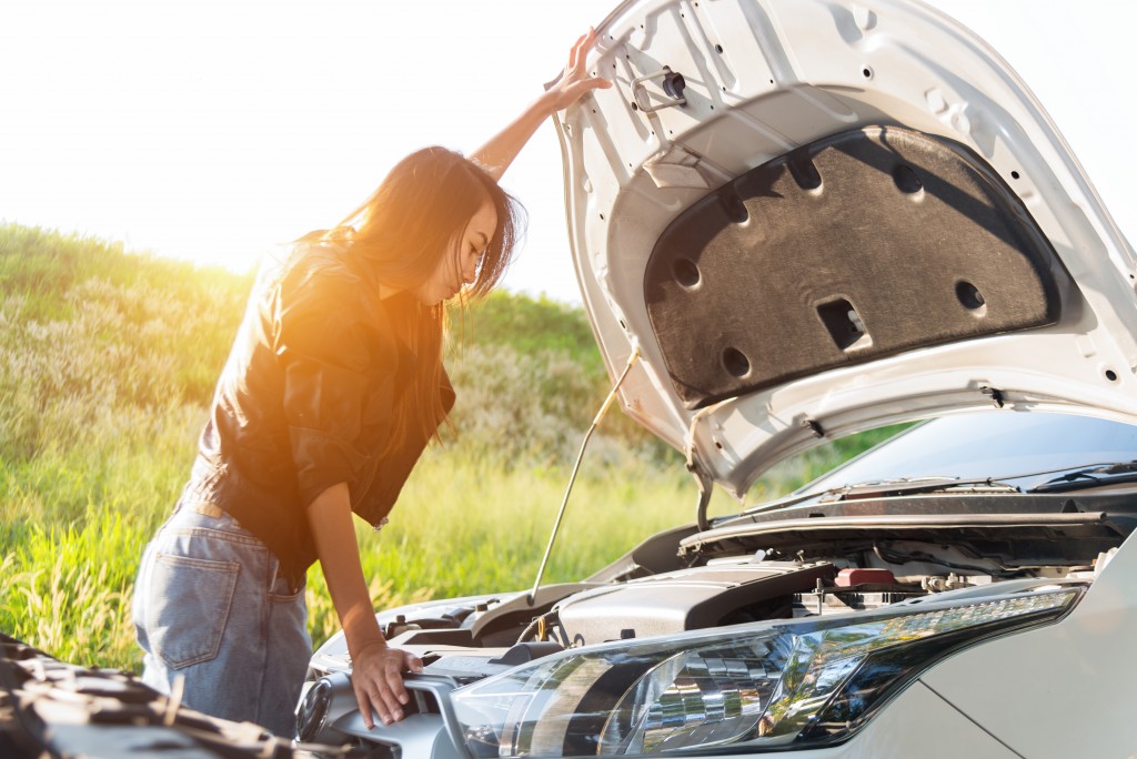 girl checking her car's engine