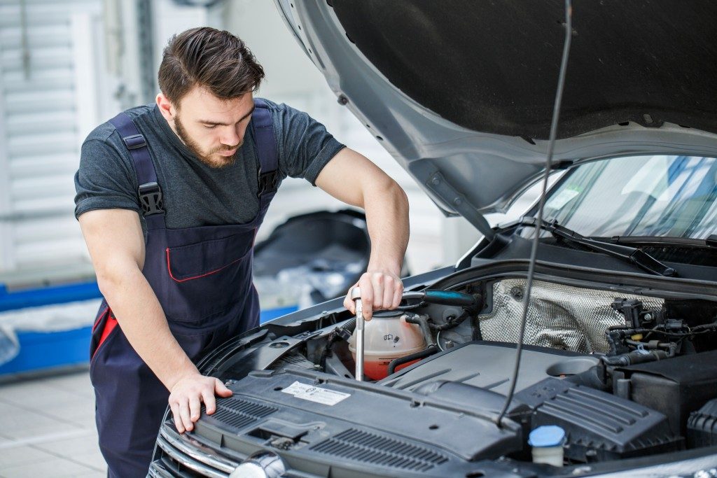 mechanic checking the car engine