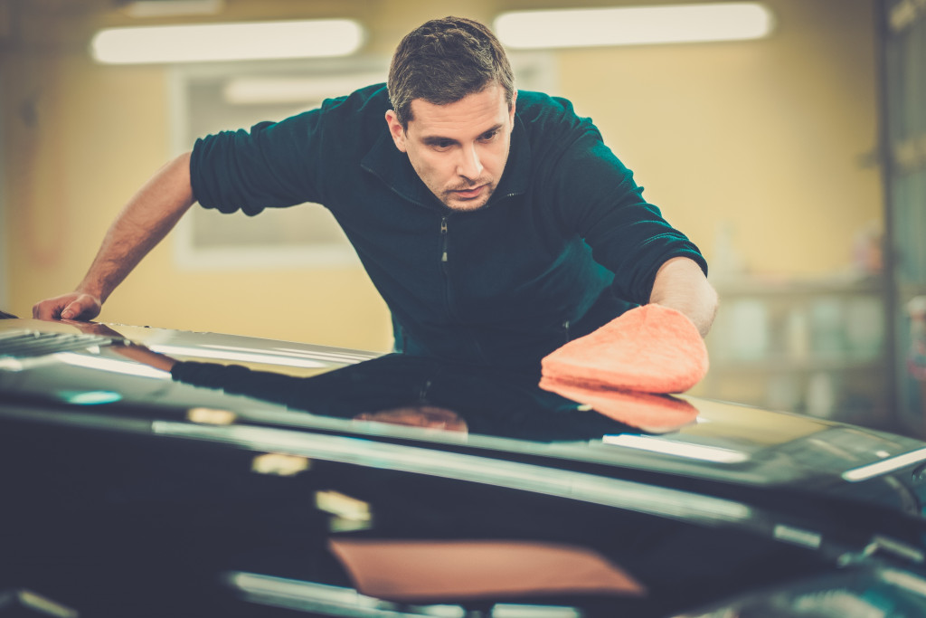 man polishing car on a carwash